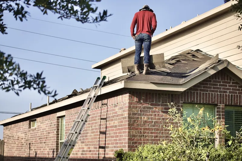 Professional roofer working on a residential roof in Elizabeth City